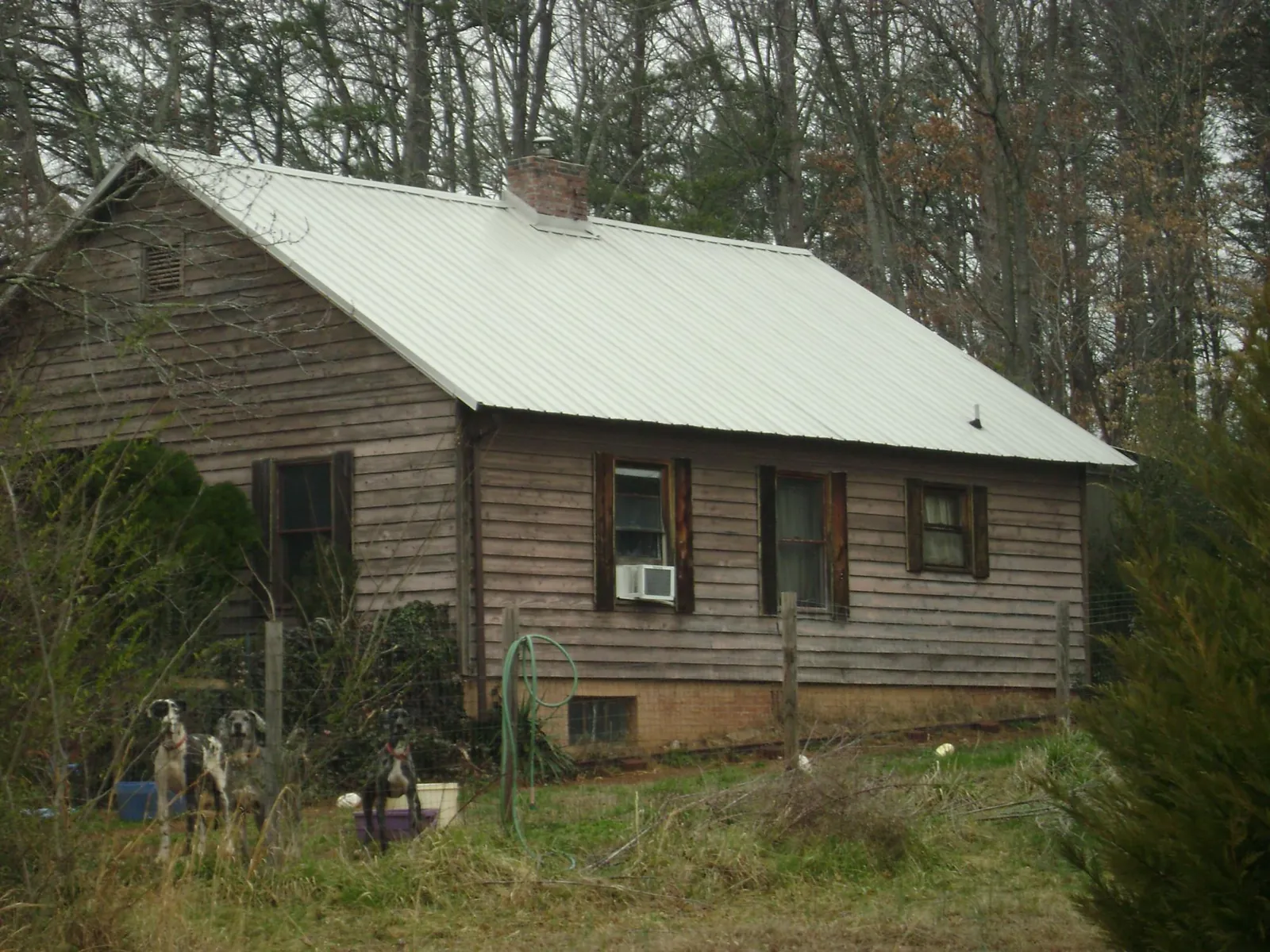 White metal roof on an old wood sided farmhouse, from a Metal Roof Installation job in Morrow